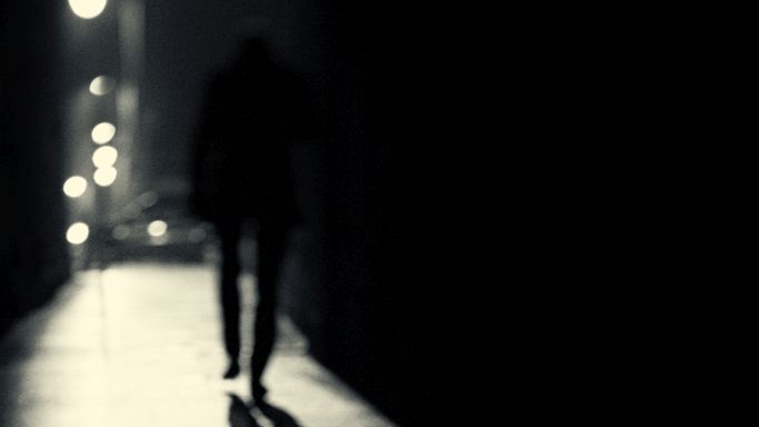 The image shows the silhouette of the back of a person at night walking alone along an underpass (Source: Donald G. Jean/Gettyimages) The image shows the silhouette of the back of a person at night walking alone along an underpass
